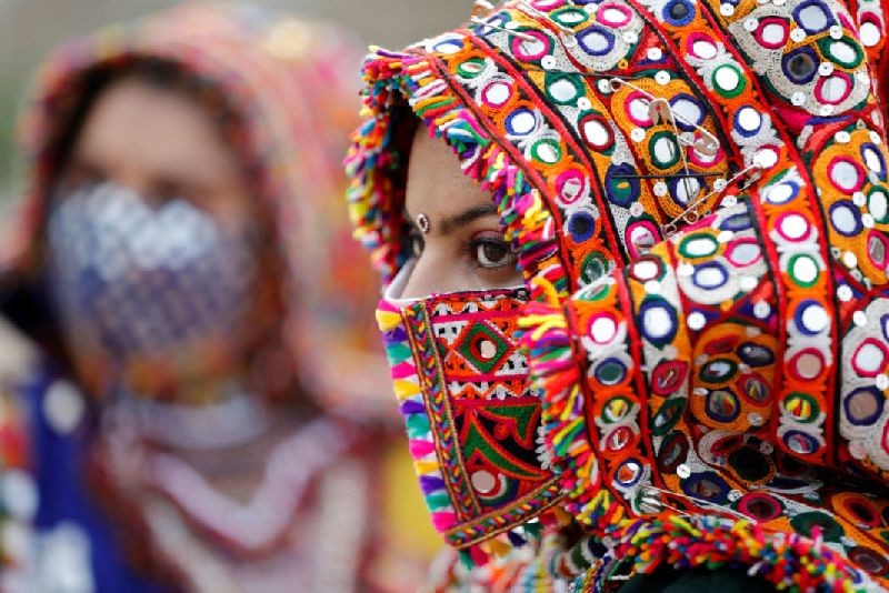 A participant in a traditional costume wearing a face mask attends a rehearsal for Garba, a folk dance, ahead of Navratri, a festival during which devotees worship the Hindu goddess Durga and youths dance in traditional costumes, amidst the coronavirus disease (COVID-19) outbreak, in Ahmedabad, India, September 12, 2020. REUTERS/Amit Dave